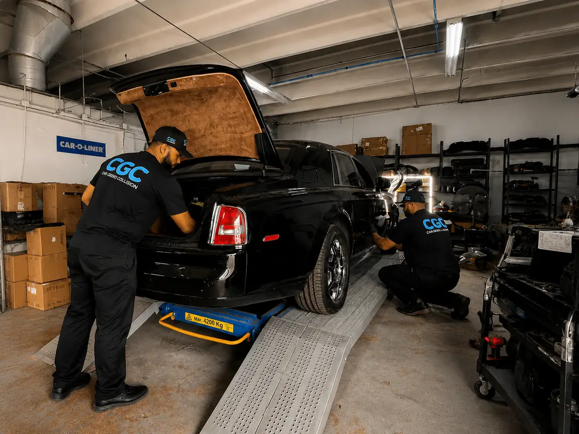 Car Geeks Collision technicians servicing a Rolls-Royce Phantom in the shop